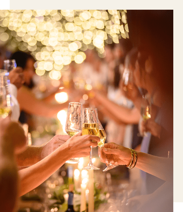 People clinking glasses in a celebratory toast.